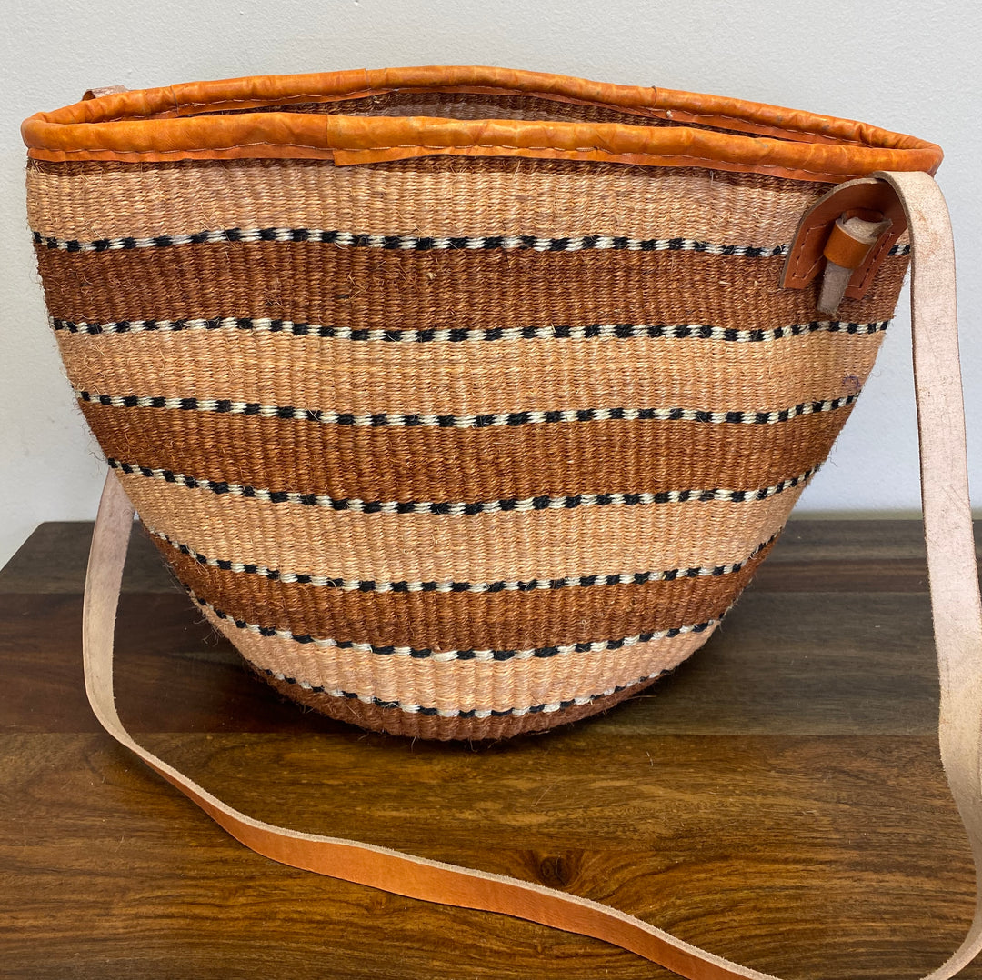 Kenyan sisal shoulder tote with casual knotted strap, sustainable design.