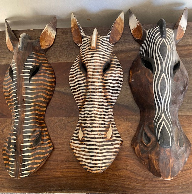 African handmade zebra masks ready to hang on wall.