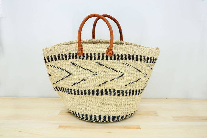 Multifunctional woven basket tote used as a picnic or weekend bag.