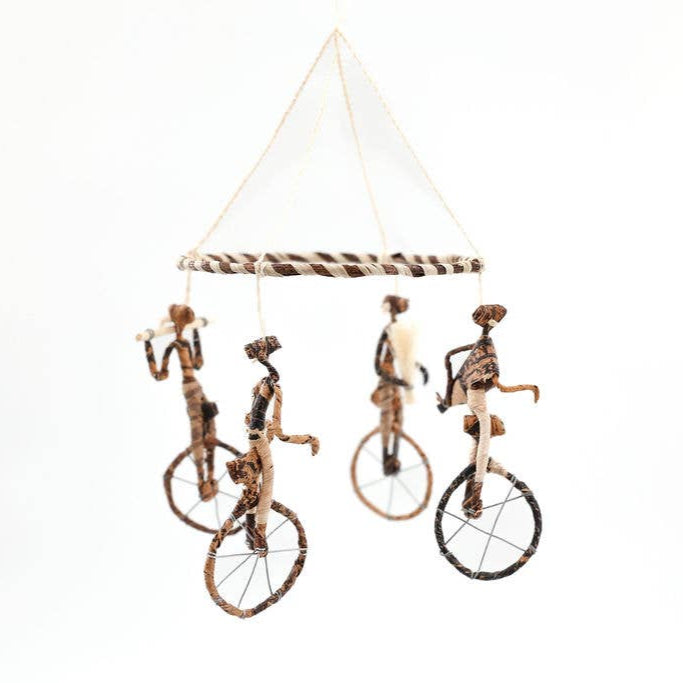 Whimsical acrobat mobile for nursery or creative décor.