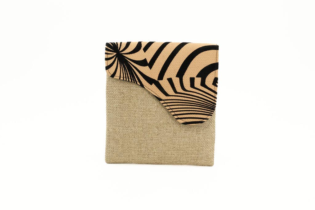 Handmade crossbody purse featuring bold safari print and vibrant colors.