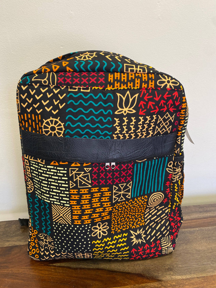 Vibrant patchwork backpack handmade in Kenya using up-cycled textile remnants, features multiple compartments and a secure zipper.