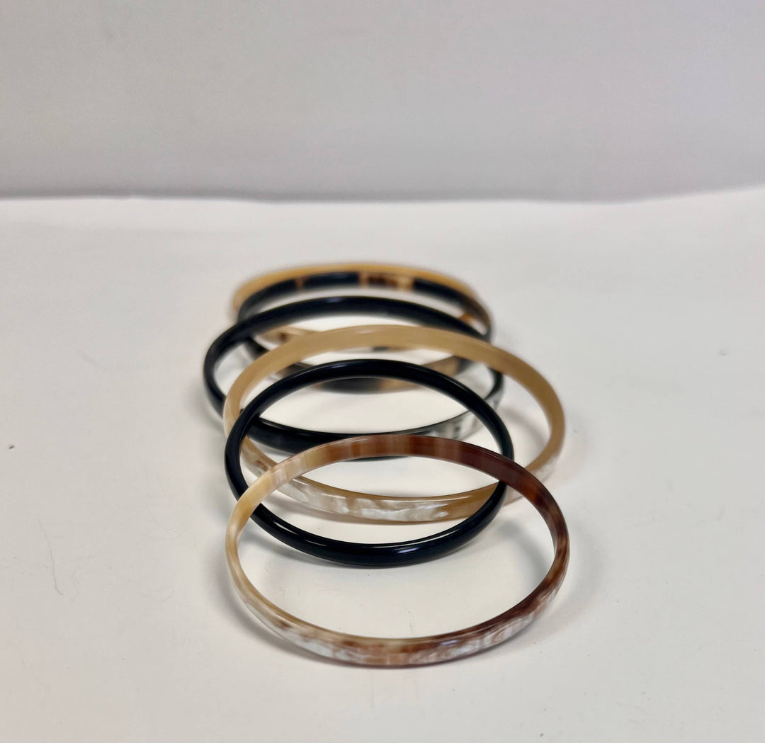 Set of six fair trade bone bangle bracelets, handcrafted from up-cycled bone with assorted colors and patterns.