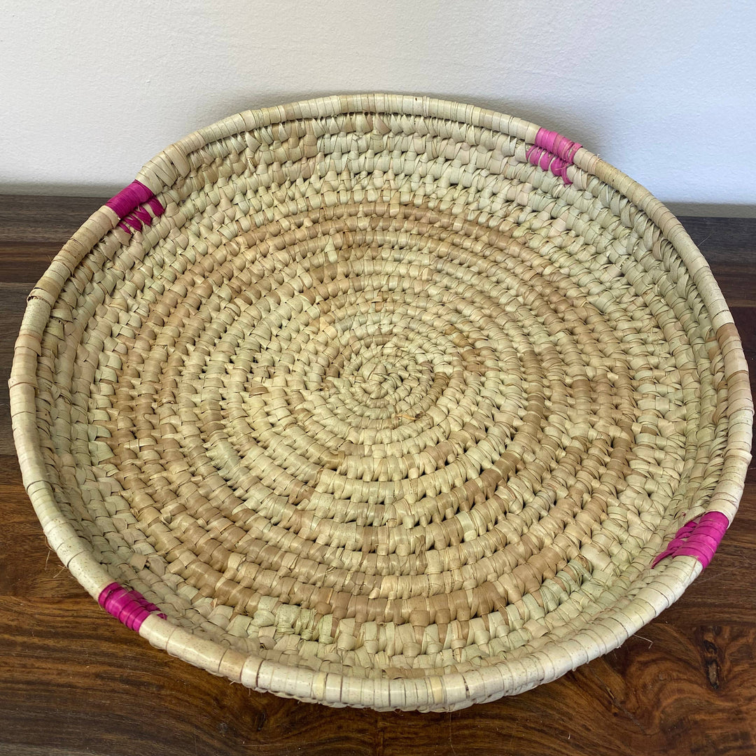 Handwoven fair trade palm leaf tray with natural finish.