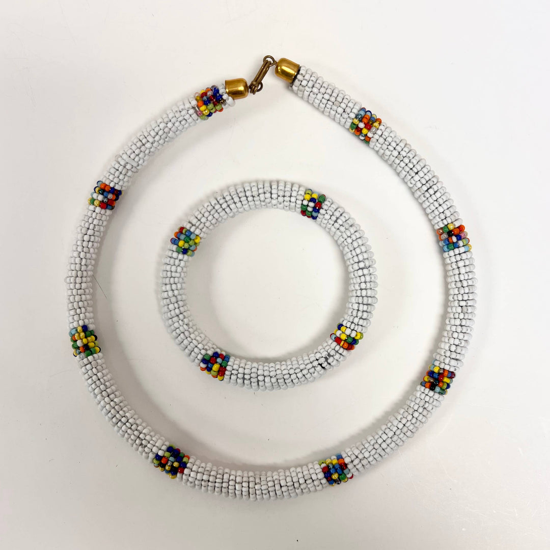Artisan-crafted white bracelet and necklace with unique African beadwork.