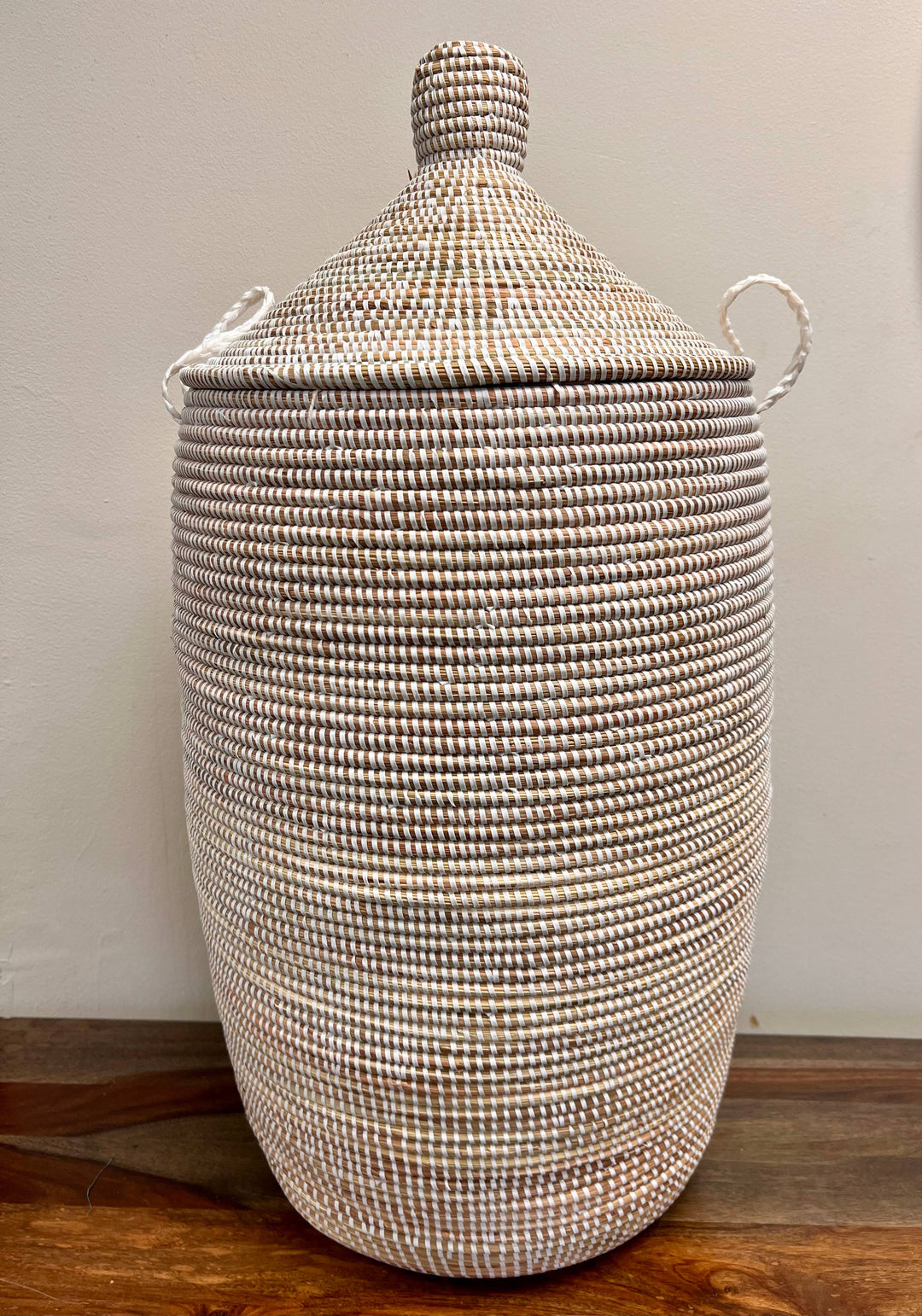 White utility basket with lid, ideal for storing laundry, blankets, or kids' items.
