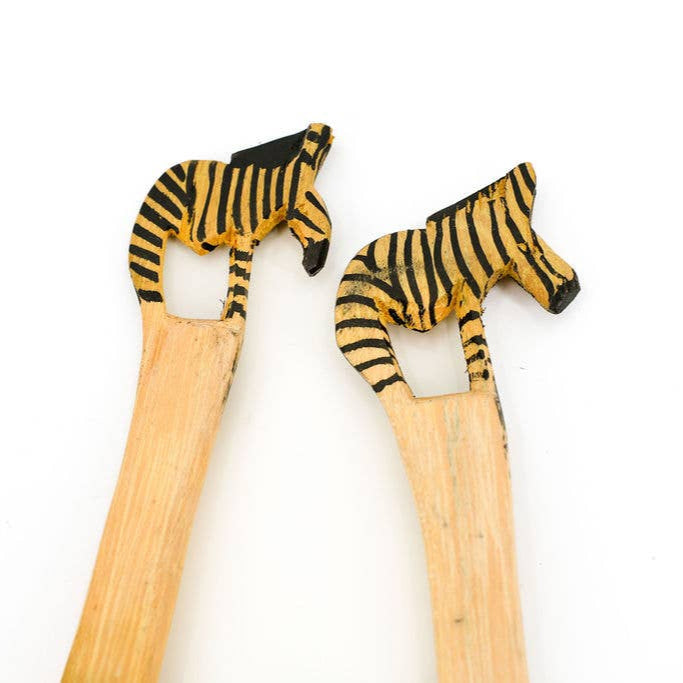 Fair trade salad servers featuring African zebra art on twisted handles.