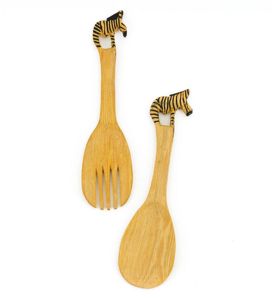 Hand-carved wooden serving spoons with painted zebra handle detail.