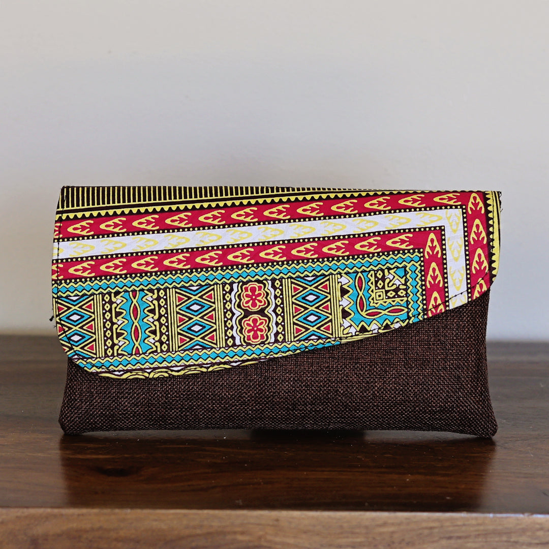 African print clutch purse with geometric stripe pattern in red, blue, and yellow