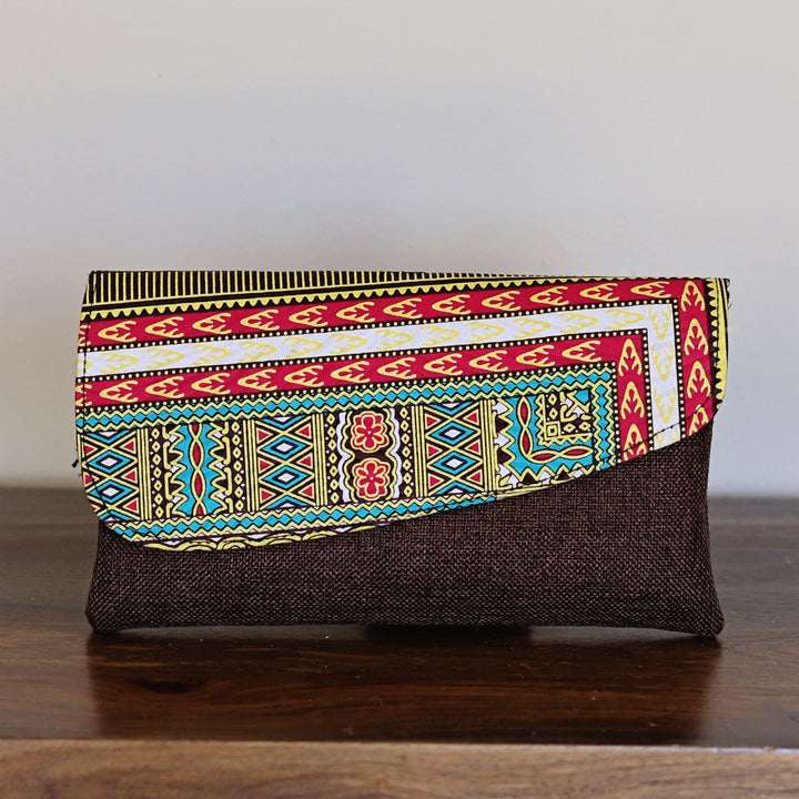 African print clutch purse with geometric stripe pattern in red, blue, and yellow