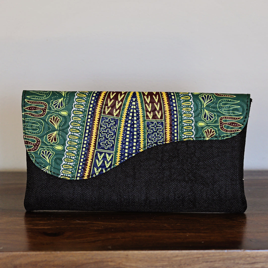 Green African print clutch purse with tribal pattern and black woven base