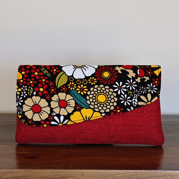 Red and black floral African print clutch purse with textured fabric base