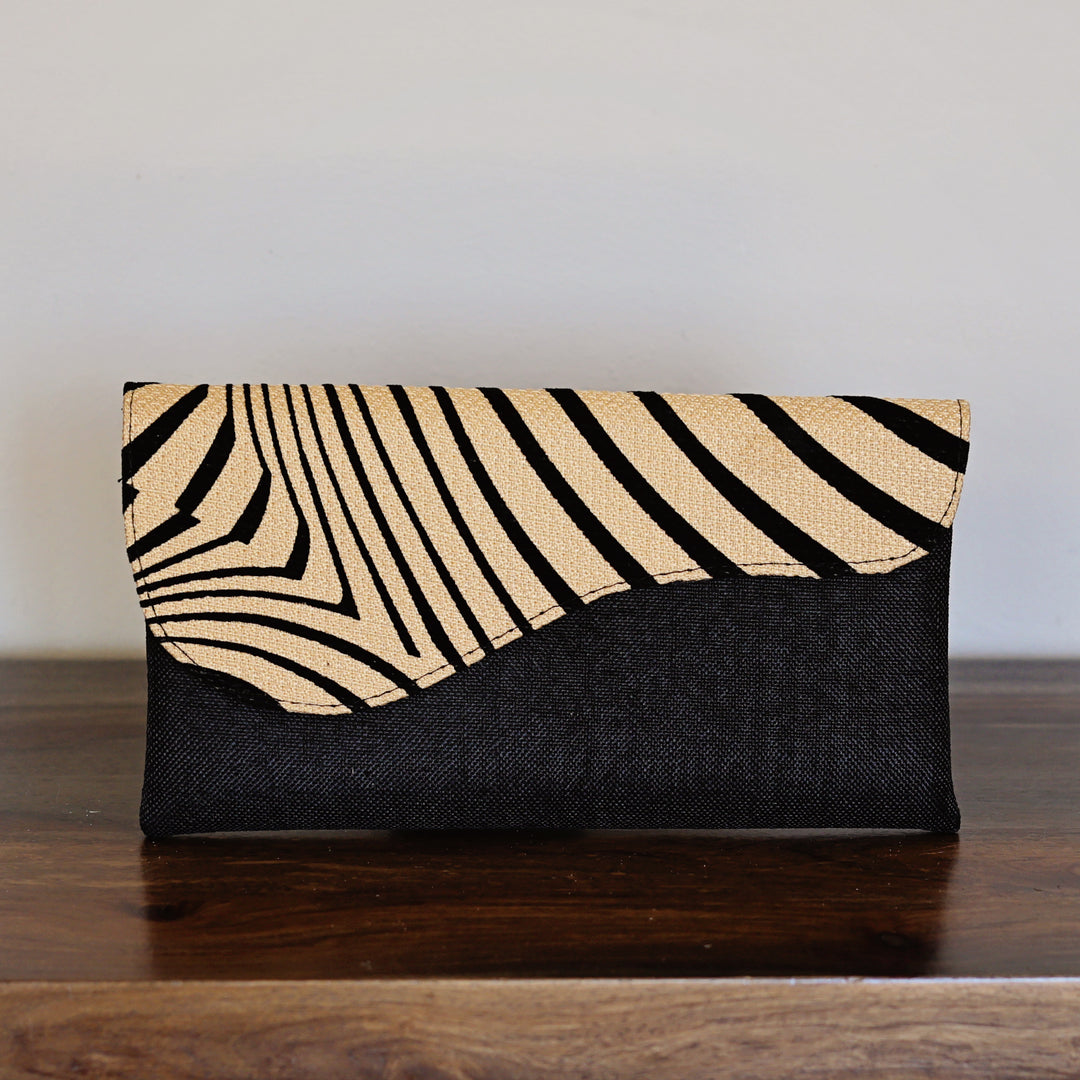 Zebra print clutch purse with black base and neutral stripe pattern flap