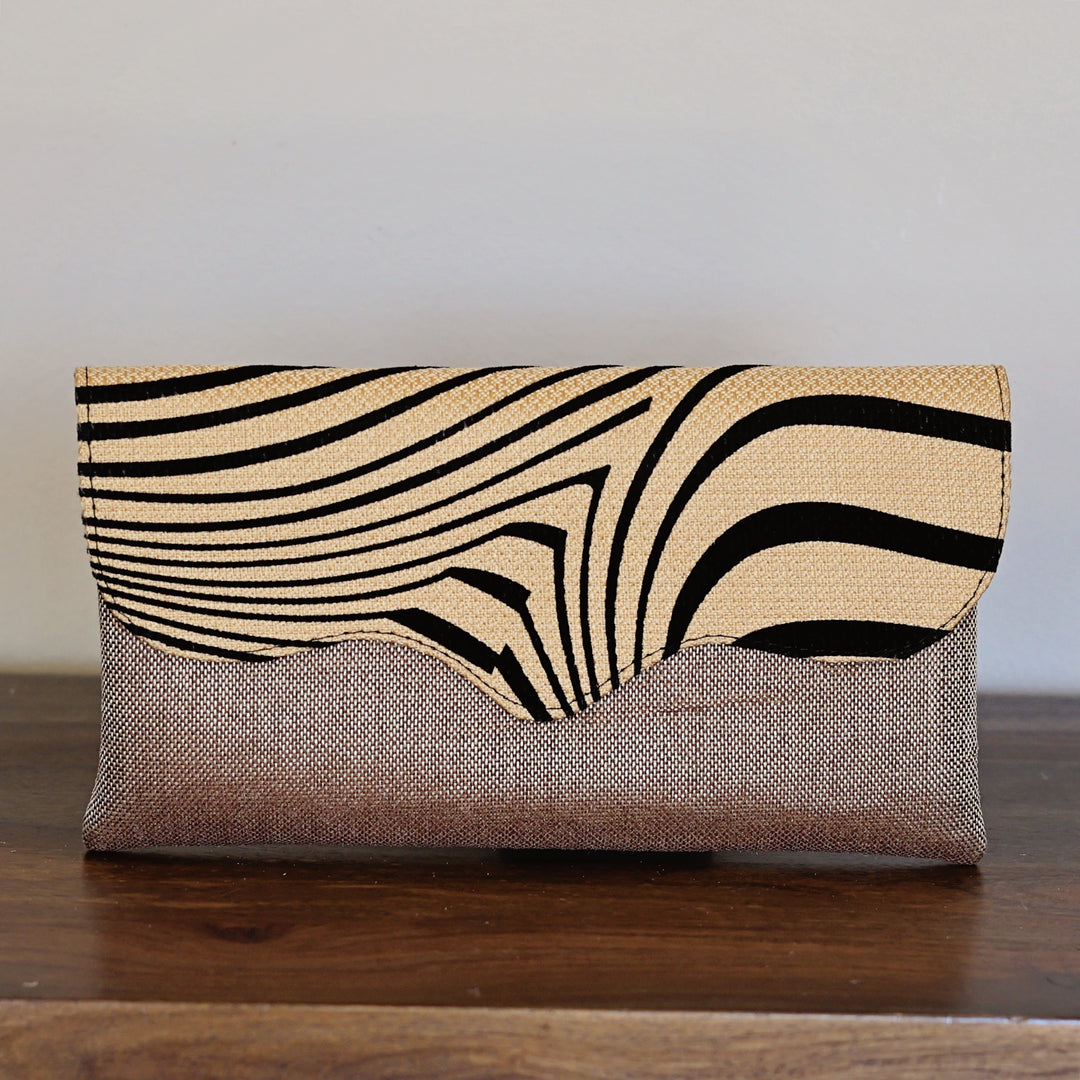 Neutral zebra print clutch purse with beige and black pattern and woven base