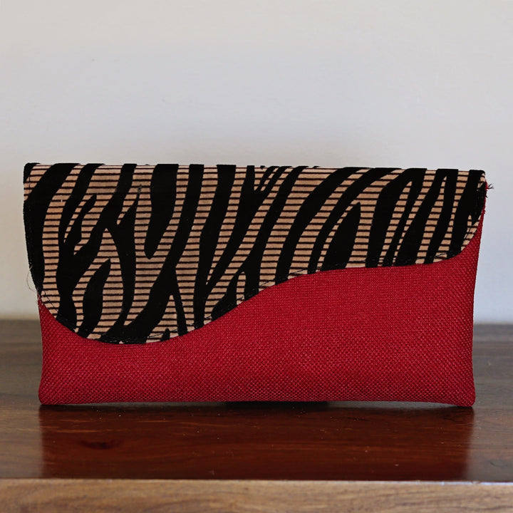 Zebra print clutch purse with bold red base and black stripe pattern flap