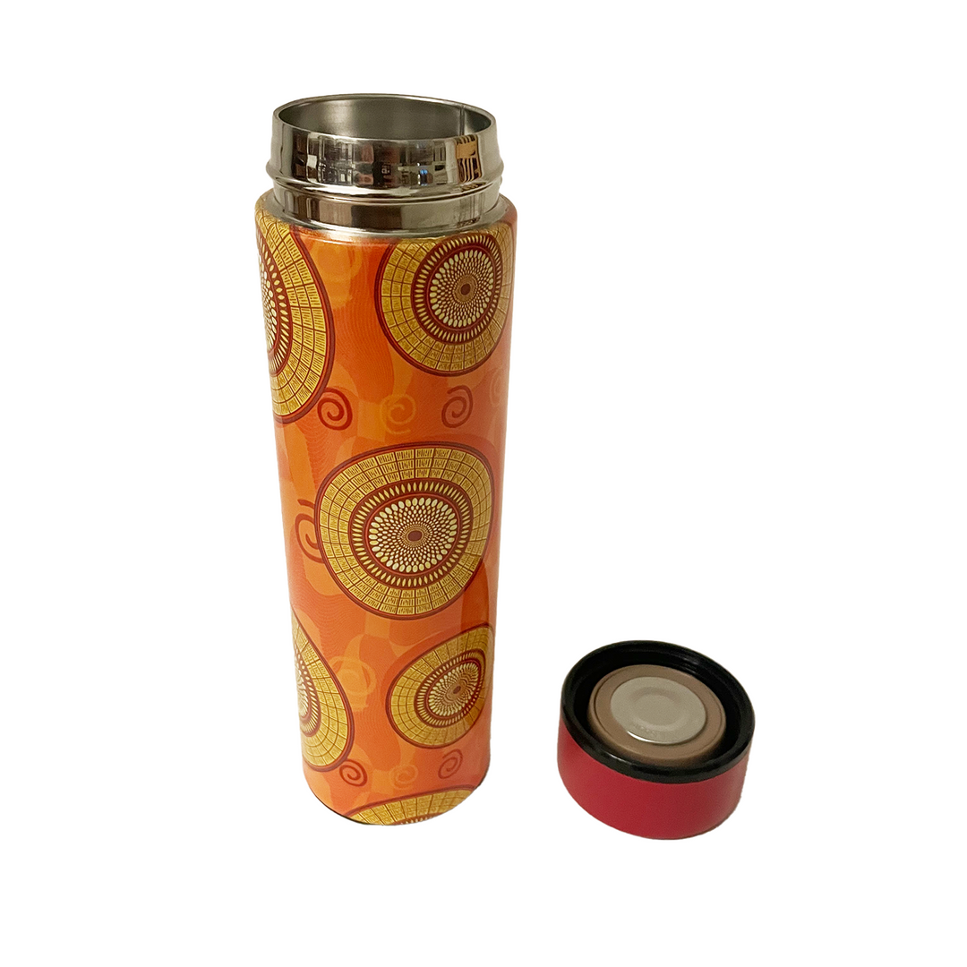 Orange thermos with gold circular patterns on a white background