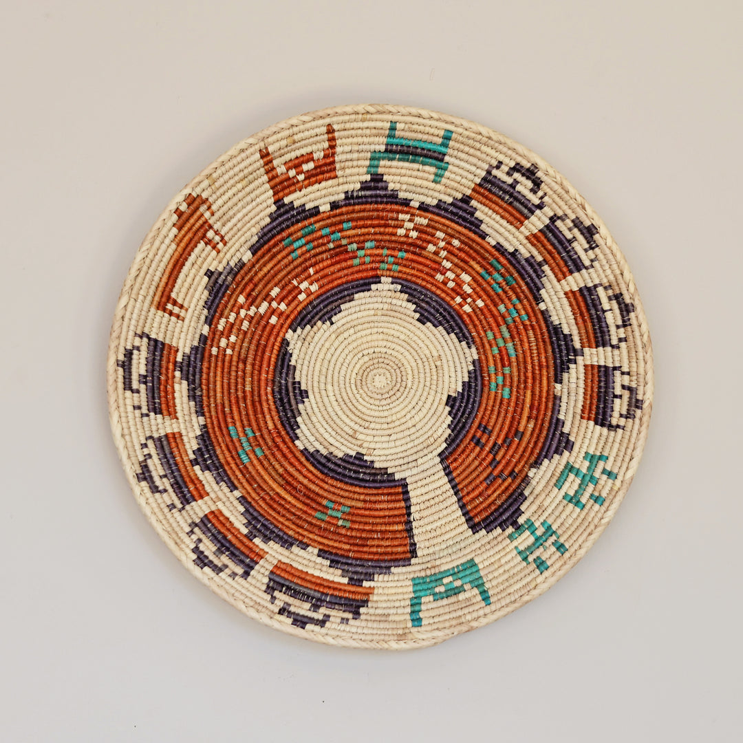 Artisan made woven bowl crafted from palm leaf and natural grass fibers