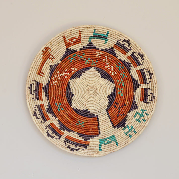 Artisan made woven bowl crafted from palm leaf and natural grass fibers