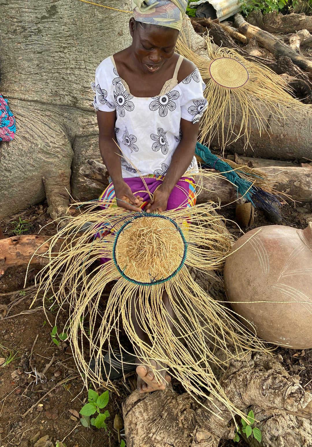 Fair-trade artisan in Africa making a U-shopper basket.