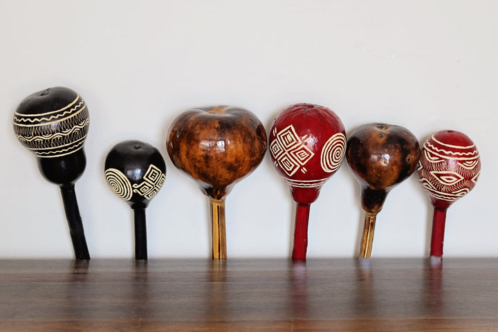 Assorted hand-carved gourd maracas from Kenya in black red and natural finishes