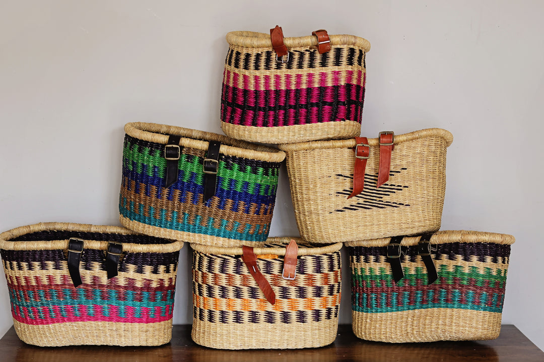 Assorted handwoven bicycle baskets from Ghana featuring colorful fair trade designs for bicycles and cycling accessories
