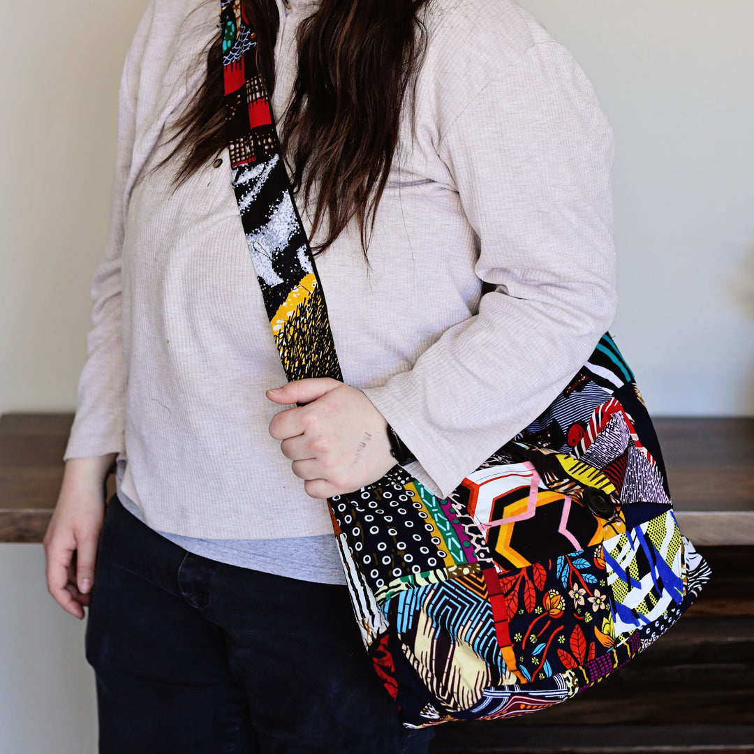 Assorted patchwork crossbody sling bags made from African fabric remnants.