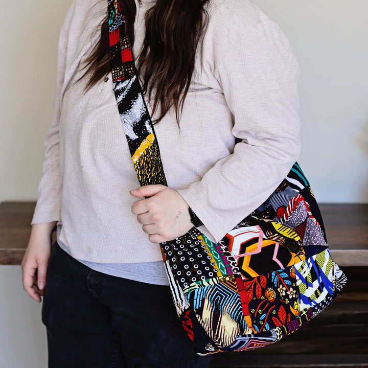 Assorted patchwork crossbody sling bags made from African fabric remnants.
