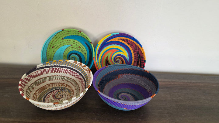 Assorted Zulu wire round bowls with vibrant colors and copper accent details