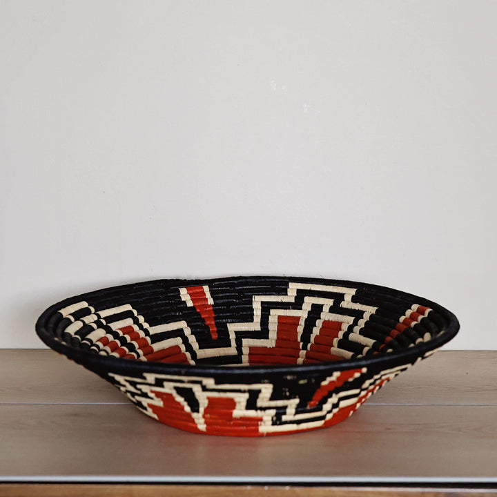 Autumn Art bukedo and raffia basket handwoven in Uganda in rust red, black, and natural ivory.