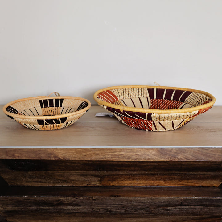 Side view of an Autumn Bukedo and Raffia bowl handcrafted in Uganda from banana leaf stalks and palm raffia in warm autumn colors.