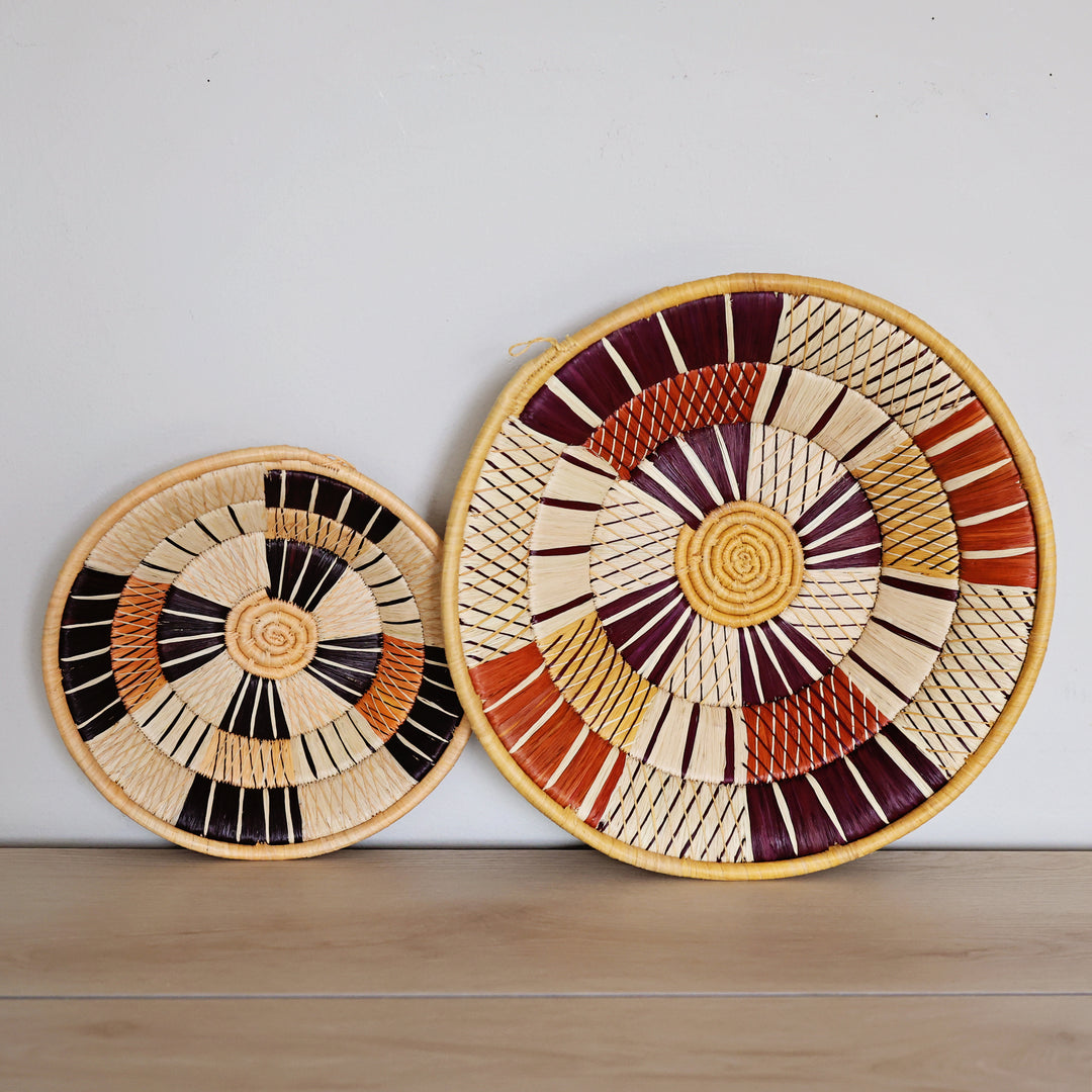 Handwoven Autumn Bukedo and Raffia bowl in natural, red, and brown tones handmade in Uganda for fair trade home décor.