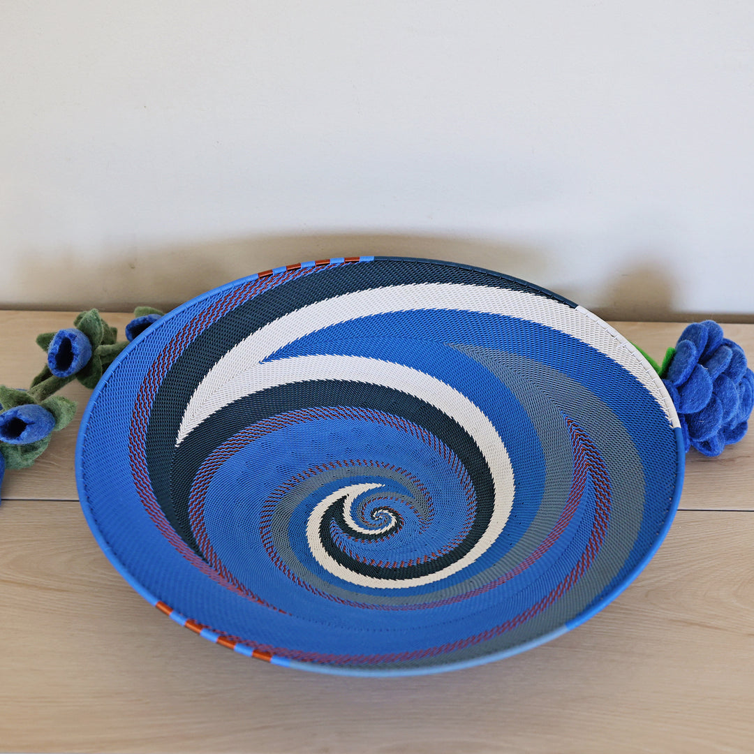 Large Beach Zulu oval tray handwoven by South African artisans in layered shades of blue and white.