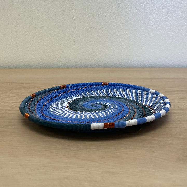 Round Zulu wire small tray basket in the Beach colorway with a handwoven blue, navy and white spiral pattern.