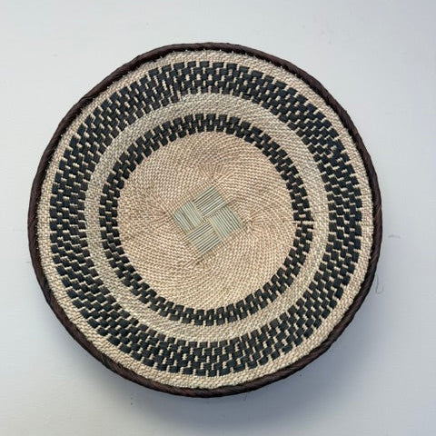Rustic Binga winnowing bowl woven from palm leaves used as a decorative tray or centerpiece