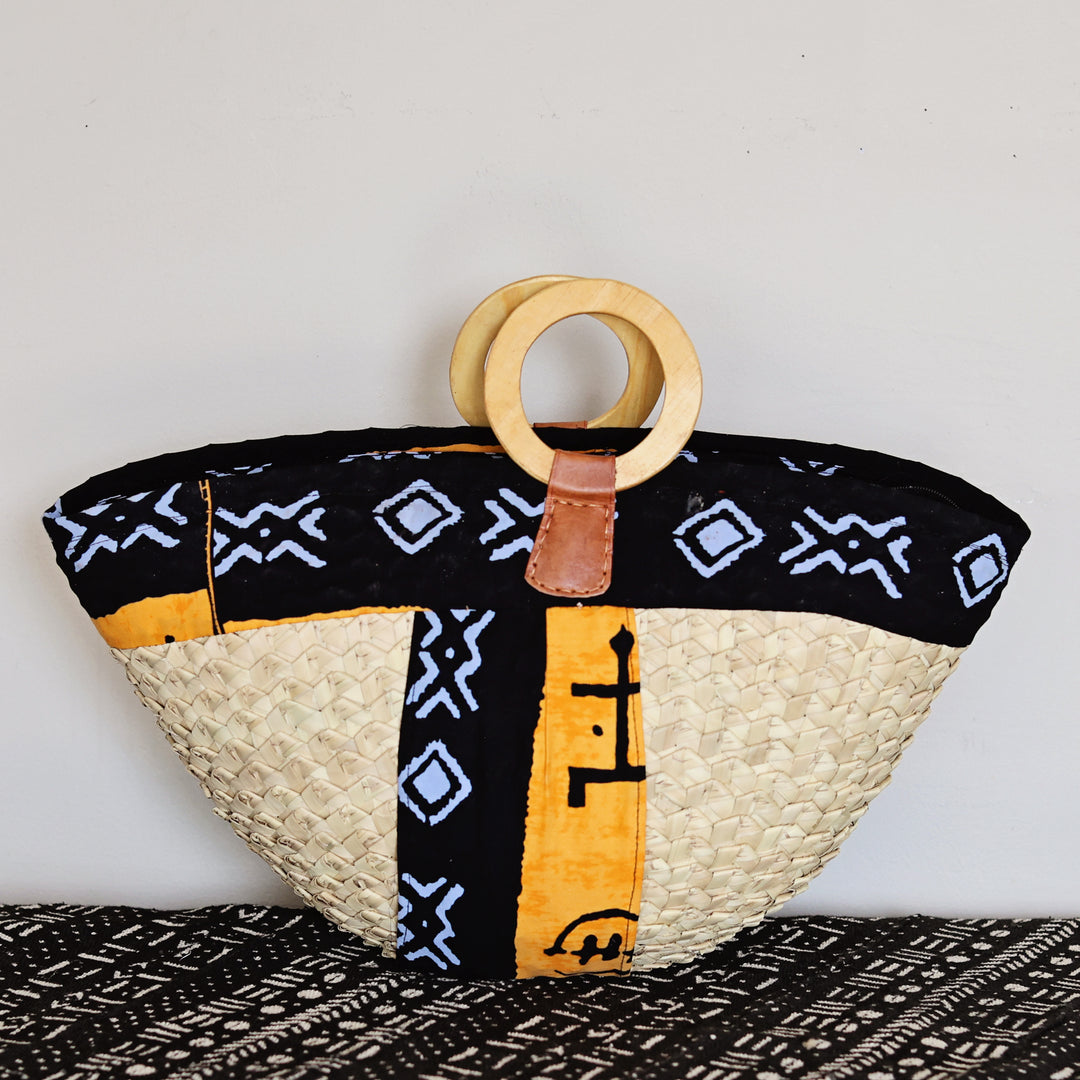 Large Kikapu Janet Tote handmade in Kenya with colorful assorted African fabric and wooden handles.