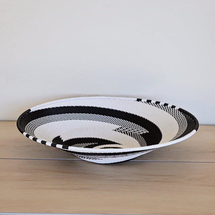 Black & White Zulu Large Shallow Basket handwoven in South Africa with a classic black and white diagonal stripe pattern.
