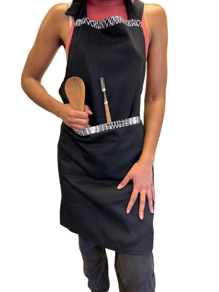 Black 100% cotton kitchen apron with vibrant African print accents handmade in Kenya.