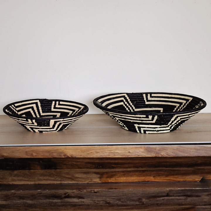Side view of a Black & White Labyrinth Bukedo and Raffia bowl handcrafted in Uganda from banana leaf stalks and palm raffia.