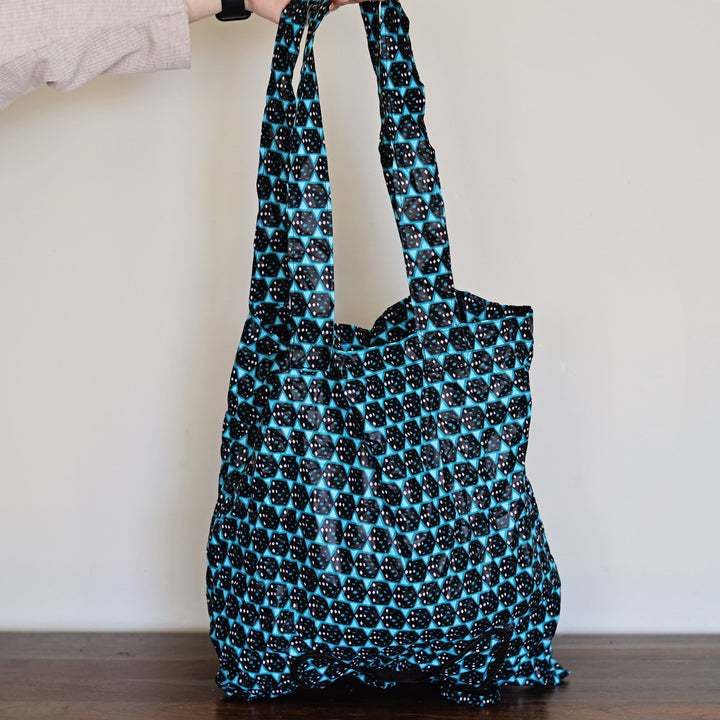 Blue and black patterned tote bag on a plain background, reusable tote.