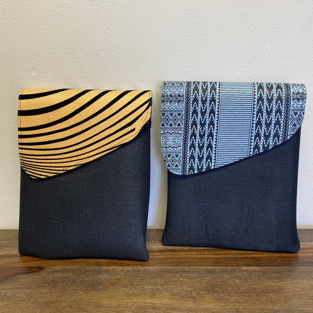 Two fabric pouches with patterned tops on a wooden surface.