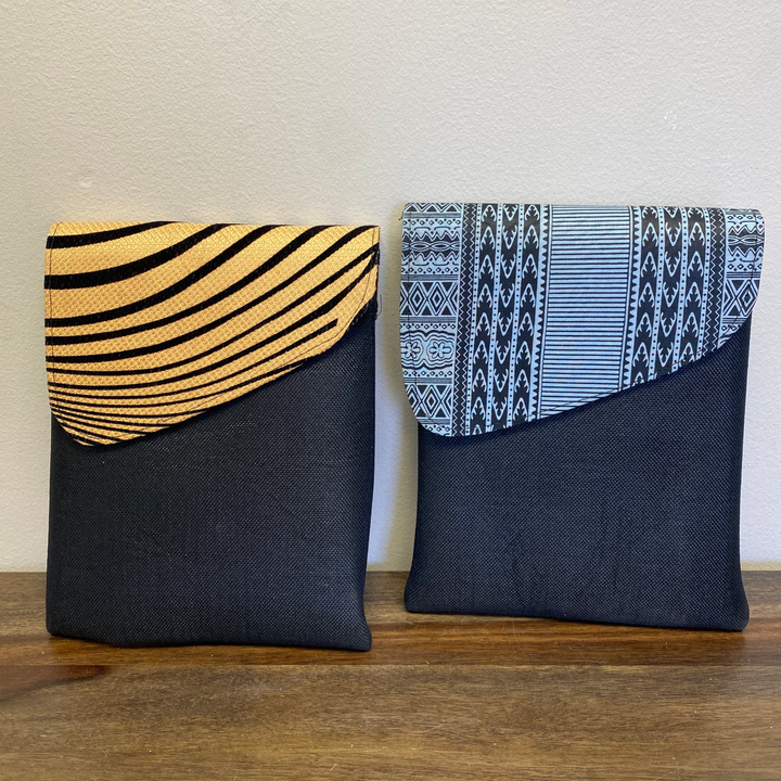 Two fabric pouches with patterned tops on a wooden surface.
