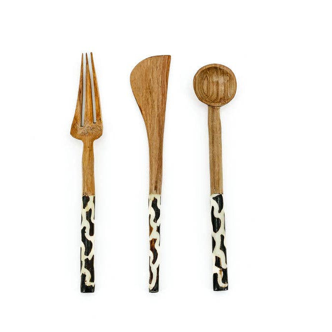 Artisan-made wood and bone cutlery set styled on a table for sustainable dining.