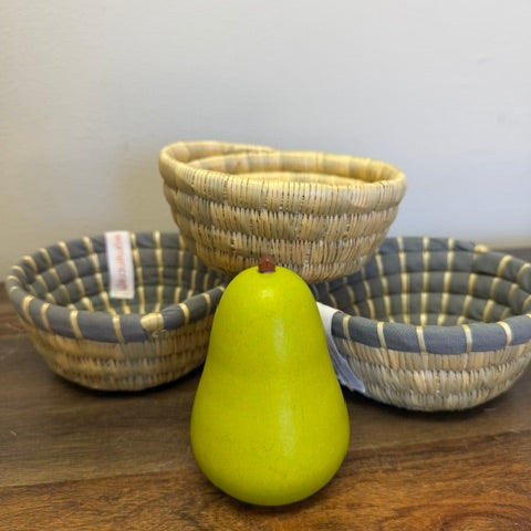 Three of our small bread baskets with a pear to show how small they are. 