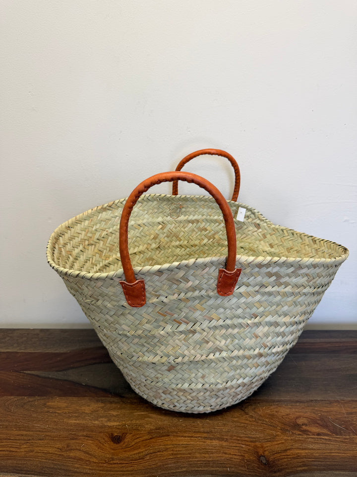 Handwoven basket with leather handles.