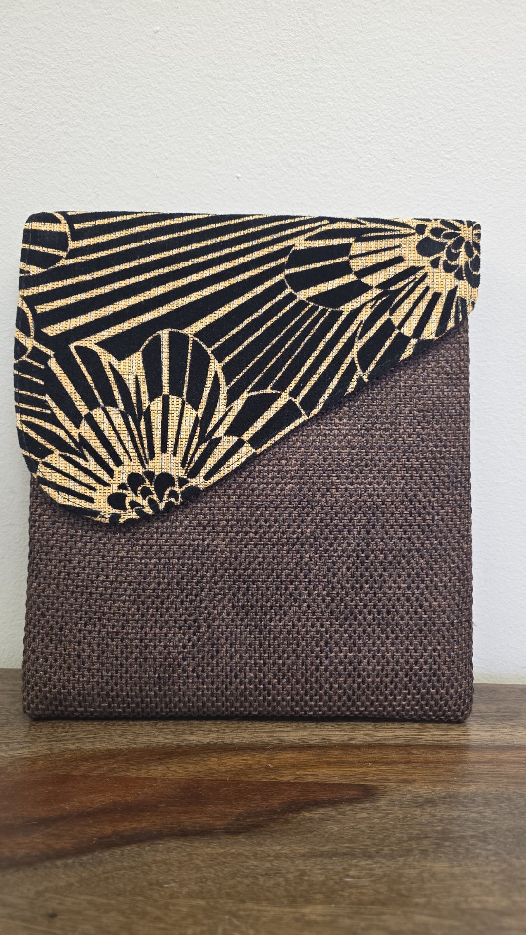 Brown crossbody bag with a zebra printed flap.