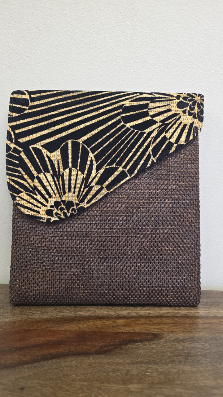 Brown crossbody bag with a zebra printed flap.