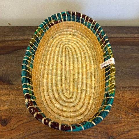 Cloth lined woven bread basket bowl with green fabric trim handmade fair trade serving basket