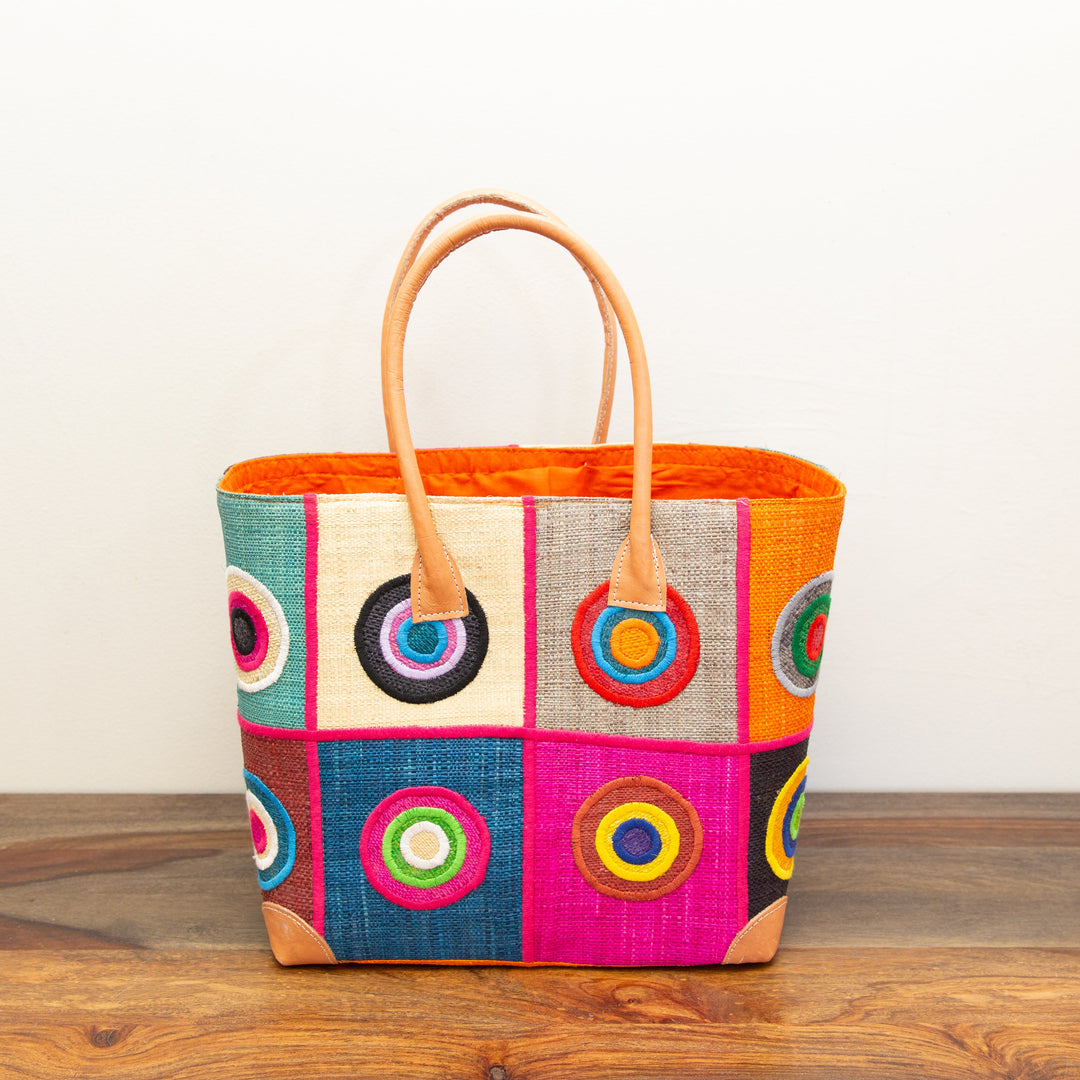 Colorful patterned tote bag with geometric pattern on the front, fair-trade and made in Africa.