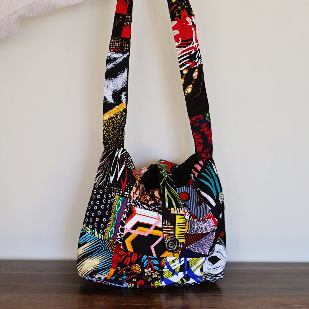 Colorful patchwork crossbody sling bag worn unisex for everyday use