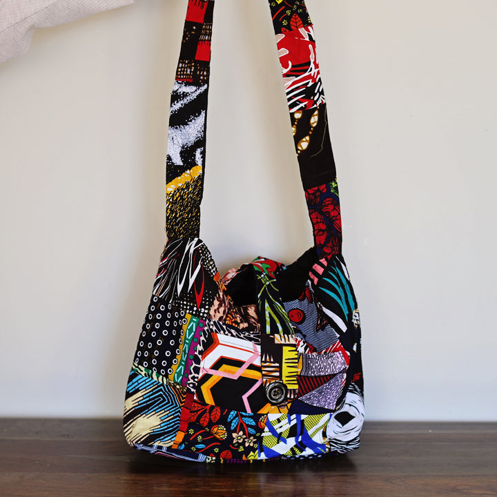 Colorful patchwork crossbody sling bag worn unisex for everyday use